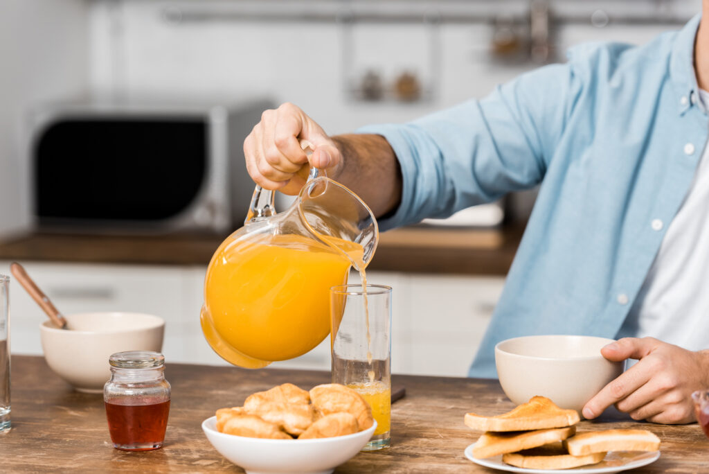 man having breakfast with honey